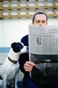 Man  and his dog reading newspaper