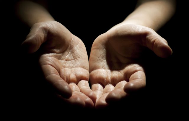 Woman's hands on black background